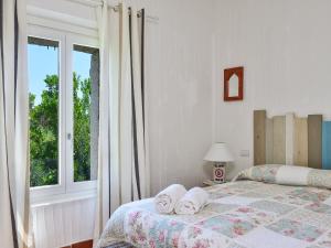 Ένα ή περισσότερα κρεβάτια σε δωμάτιο στο Villa Li Conchi 15 +23 φωτογραφίες