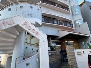a building with a sign in front of it at Joyful Rose in Ginowan +13 photos