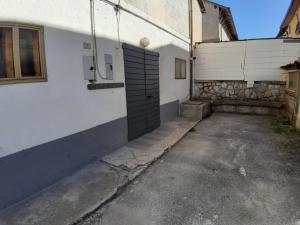 a building with a garage door on the side of it at casa tata fino a 6 posti letto in Roccaraso