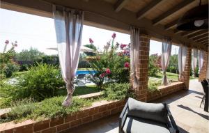 a patio with curtains and a pool in the background at Villa Astarea in Vodnjan +22 photos
