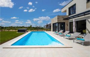 a swimming pool in the backyard of a house at Villa Primavera in Brtonigla