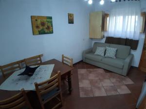a living room with a table and a couch at casa tata fino a 6 posti letto in Roccaraso