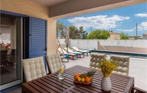 a table with a bowl of fruit on a balcony at Villa Karla Nin in Nin