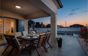 a dining room with a table and chairs on a patio at Villa Karla Nin in Nin