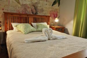 ein Schlafzimmer mit einem Bett mit zwei Handtüchern darauf in der Unterkunft Hostel Jardins de São Luís in Setúbal