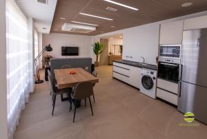 a living room with a table and a kitchen at Mirasierra in Mancha Real