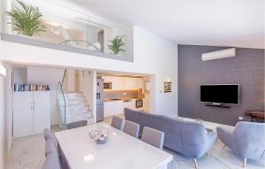a living room with a white table and blue chairs at Villa Libertas in Mlini +19 photos