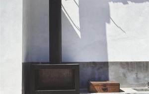 a fireplace with a letter n on a wall at Villa Petit in Radetići +13 photos