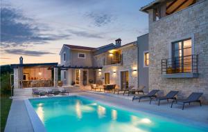 a house with a swimming pool in front of a house at Villa Maya in Štuti
