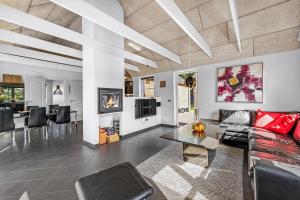 a living room with a couch and a table at Beautiful Holiday Home With Spa And Sauna, Close To The North Sea And The Center Of Søndervig in Ringkøbing