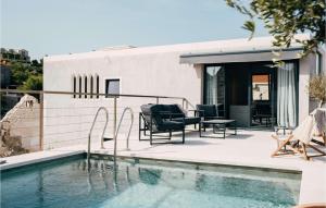 a house with a swimming pool next to a building at Villa Breakaway in Selca