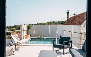 a patio with a swimming pool and chairs at Villa Breakaway in Selca