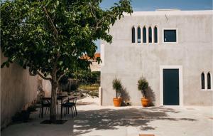 a building with chairs and a tree in front of it at Villa Breakaway in Selca