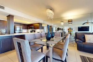 a dining room and kitchen with a table and chairs at Ocean Vista Condominiums #407 in South Padre Island