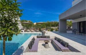 a house with a swimming pool with a bench next to it at Villa Opal in Zadar