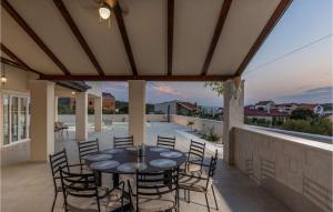 a patio with a table and chairs on a balcony at Villa Stina Murter in Jezera