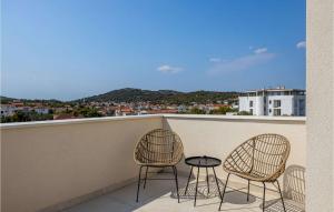 two chairs and a table on a balcony at Villa Stina Murter in Jezera
