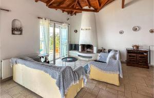 a living room with a couch and a fireplace at Cozy Home In Kitries Kalamata in Kitriaí