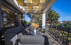 a patio with a couch and chairs on a balcony at Villa Olea Vir in Vir +39 photos