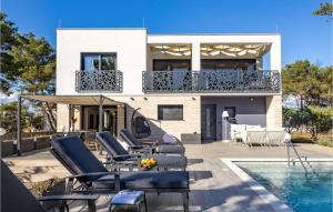 a house with lounge chairs and a swimming pool at Villa Olea Vir in Vir