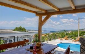 a patio with a table and a swimming pool at Villa Ancora in Jadranovo