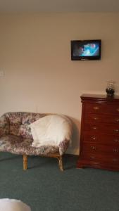 a living room with a couch and a tv on the wall at Riverview House in Athlone