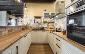 a kitchen with white cabinets and wooden counter tops at Villa Stella Del Lago in Vrana