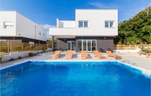 a house with a swimming pool in front of a house at Villa Valentina in Pag