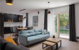a living room with a blue couch and a kitchen at Villa Dali in Sičane