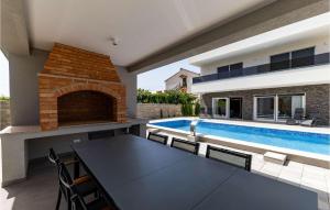 a patio with a table and a swimming pool at Villa Gina in Sukošan +28 photos