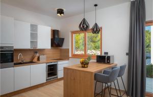 a kitchen with white cabinets and a wooden counter top at Villa Quentin in Vodice