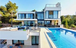 a house with a swimming pool next to a house at Villa Sunlight in Ždrelac