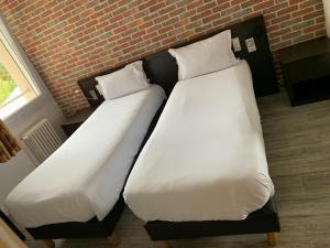 Postel nebo postele na pokoji v ubytování Hotel Au Spatial