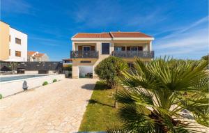a villa with a swimming pool and a house at Villa Palma Zaton in Zaton