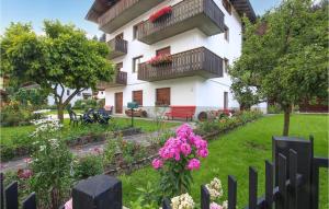 a garden in front of a building with flowers at Cozy Apartment In Fiera Di Primiero in Fiera di Primiero +18 photos