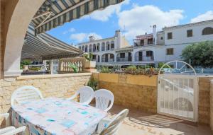 a patio with a table and chairs and a building at Gorgeous Home In Santa Pola With Wifi in Santa Pola