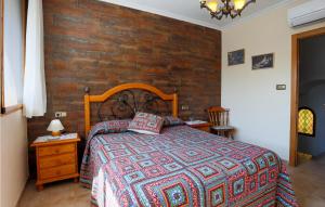 a bedroom with a bed and a wooden wall at Gorgeous Home In Santa Pola With Wifi in Santa Pola