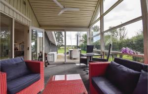 a screened in porch with couches and a table at Three-Bedroom Holiday Home In Otterup in Otterup