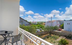 a balcony with a table and a view of a city at Lovely Apartment In Brodarica With Wifi in Brodarica