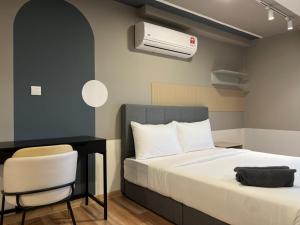 a bedroom with a bed and a desk and a air conditioner at Arte cherass by Sweet home in Kuala Lumpur