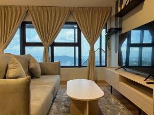 a living room with a couch and a table at Arte cherass by Sweet home in Kuala Lumpur