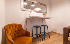 a room with a chair and a table and stools at Cozy Apartment In Arcos De La Frontera in Arcos de la Frontera