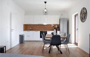 a kitchen and dining room with a table and chairs at Lovely Apartment In Brodarica With Wifi in Brodarica