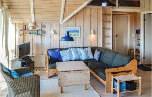 a living room with a couch and a table at Holiday Home Slettevej Ii in Skagen