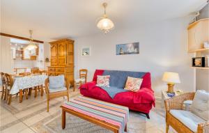 a living room with a red couch and a table at 2 Bedroom Stunning Home In Fécamp in Fécamp