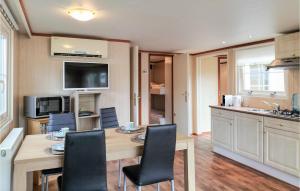 a kitchen with a table and chairs in a kitchen at Nice Home In Heinkenszand With Wifi in Heinkensand