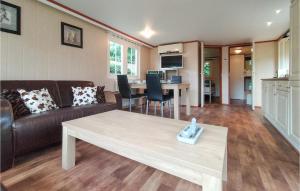 a living room with a couch and a table at Nice Home In Heinkenszand With Wifi in Heinkensand