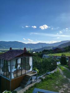 a gazebo with a bench and mountains in the background at Jirigourmoe in Gurye