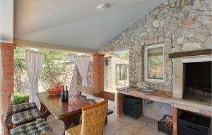 a living room with a stone fireplace and a wooden table at Villa Valencan in Rovinj