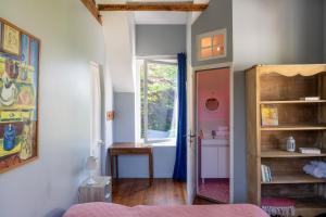 a bedroom with a door open to a bathroom at Villa Mathilde in Saint-Pierre-en-Port